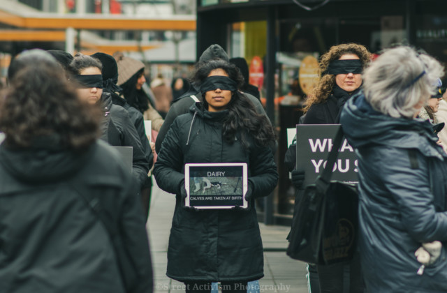 Women standing in a Save Square formation, wearing blindfolds